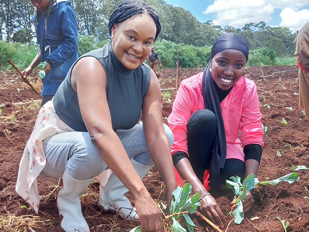 Prof. Catherine Kunyanga Planting Kale at the Field Station Farm.