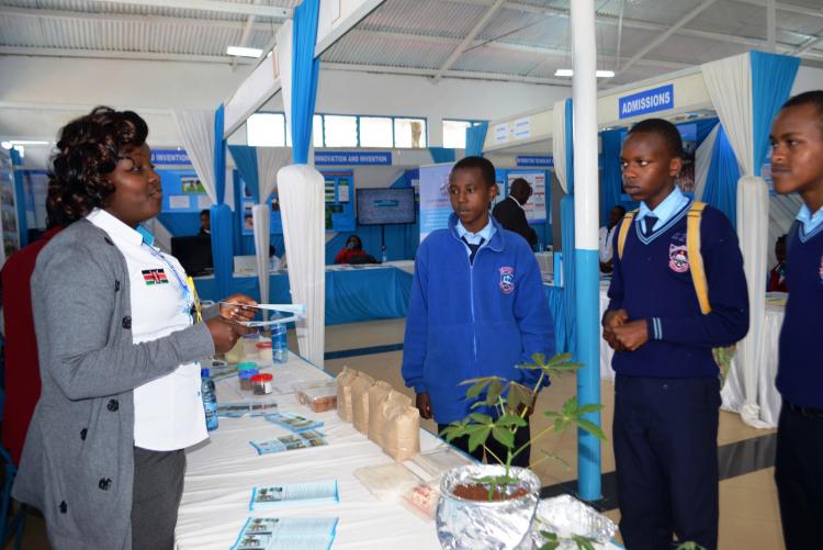 CAVS participant explaining to some of  Students who visited the stand the importance of Agricultural Innovations, food safety and quality .